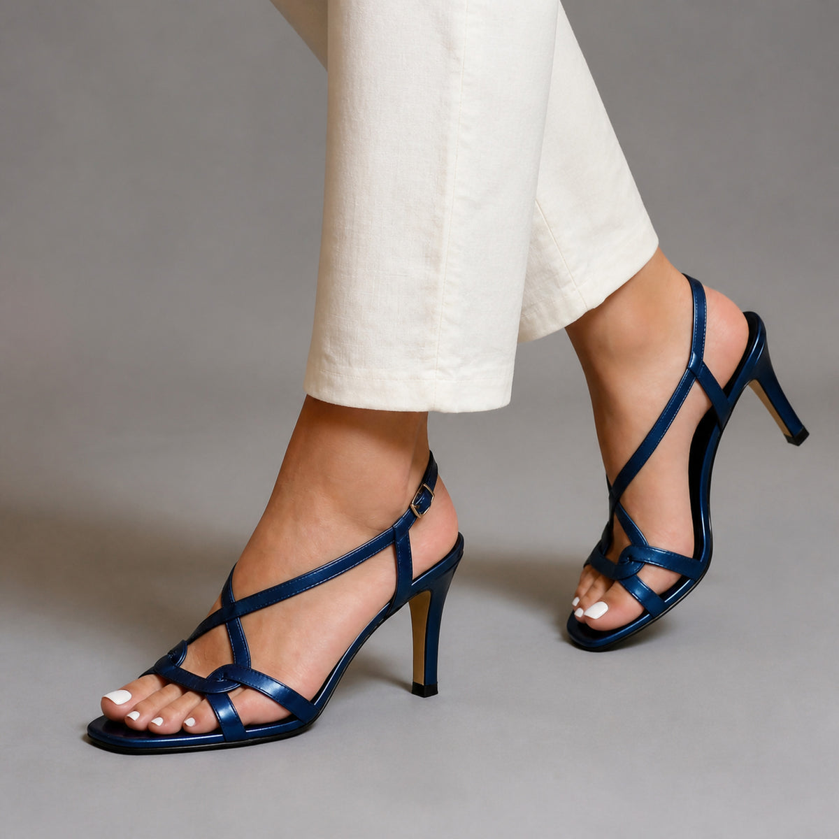 Aurelia Heels in dark blue, worn mid-step