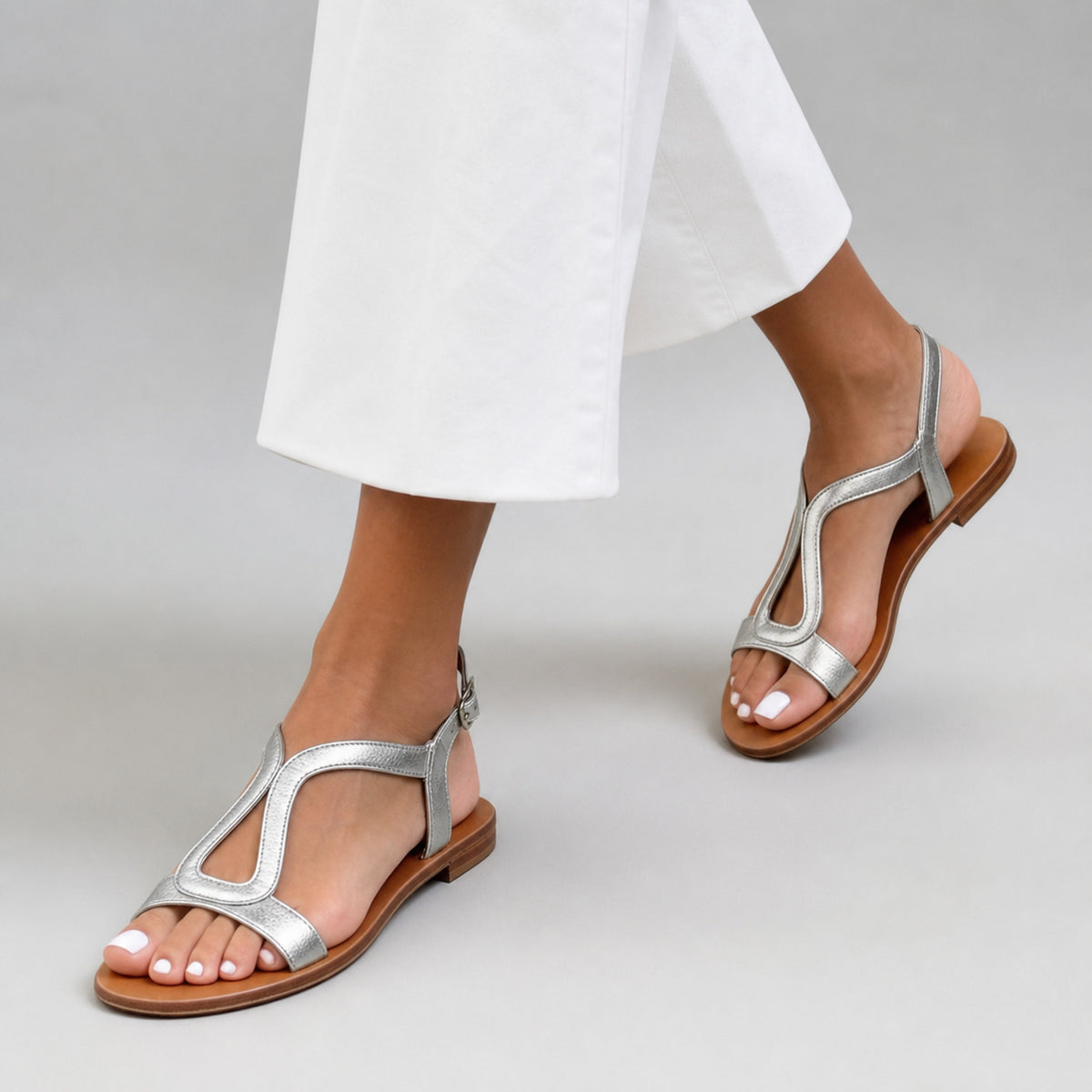 Elsie T-Bar Sandals in grey, worn mid-step