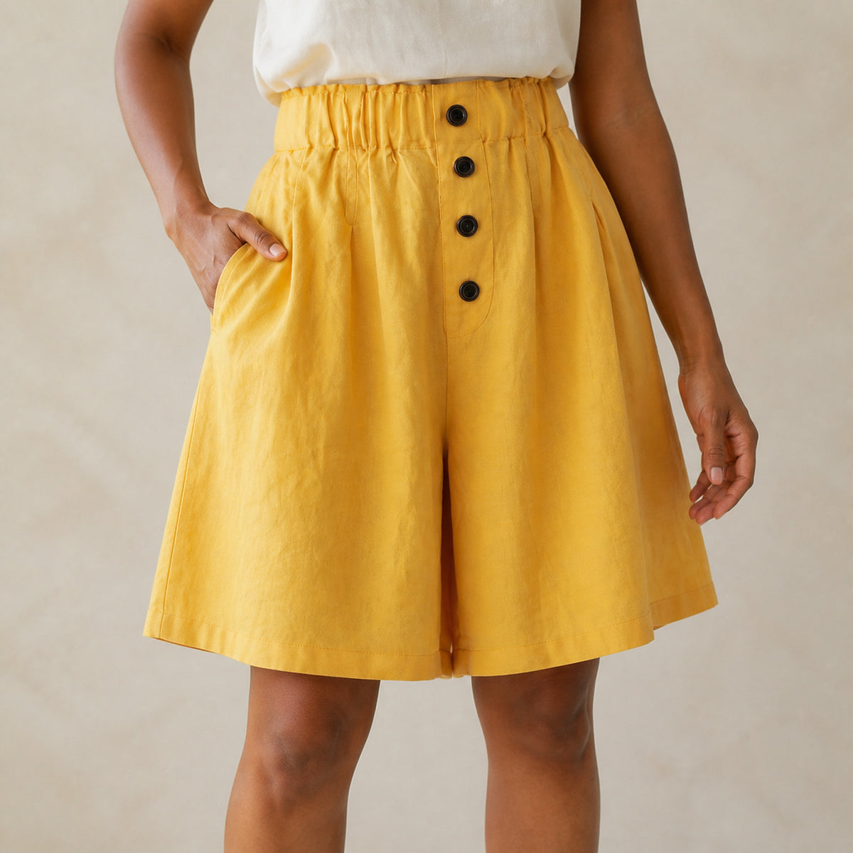 Close-up of the button placket and pocket on the Wren shorts