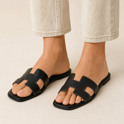 Nia Flat Slides in black, front view