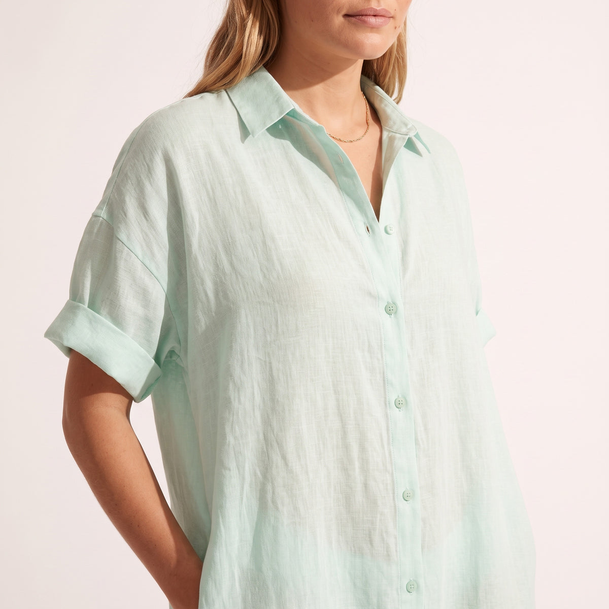 Close-up of the collar and rolled sleeve on the Maeve Oversized Linen Dress in mint green