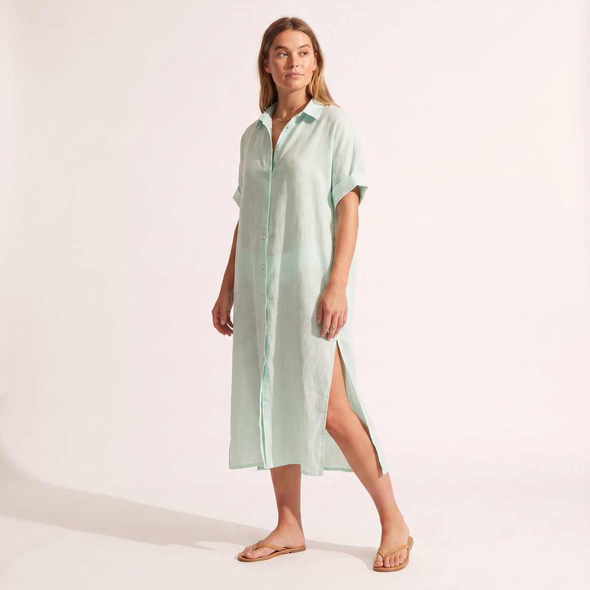 Maeve Oversized Linen Dress in mint green, three-quarter view mid-stride